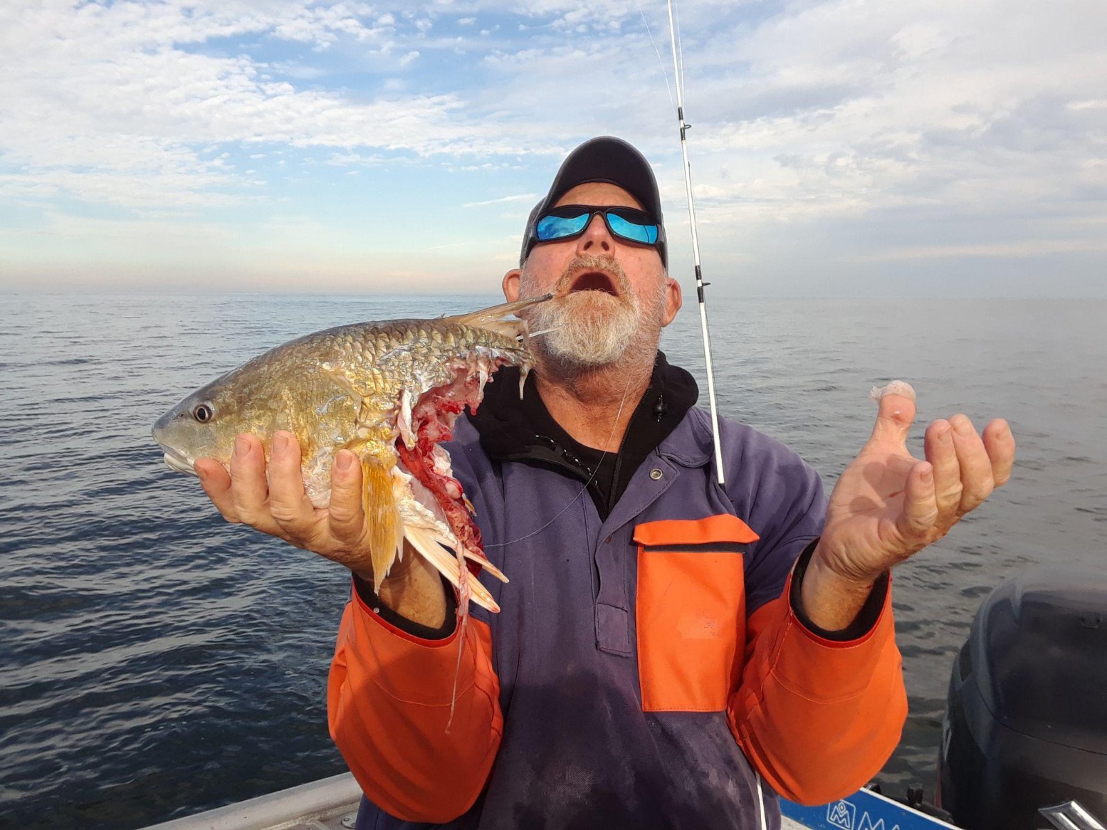 Capt. Dave holding a redfish on his private inshore fishing charter in Jacksonville, Florida